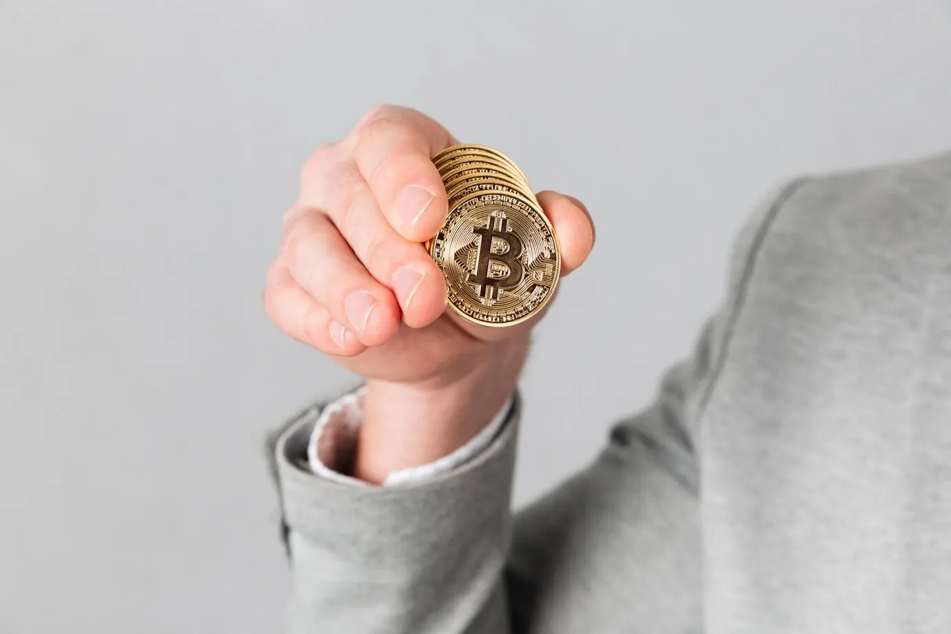 Asmuo laiko Bitcoin monetą. Kriptovaliuta, finansai, investicija.